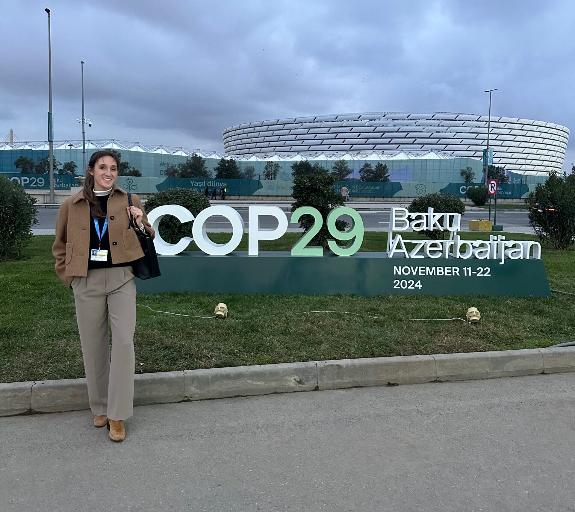 Picture of Anna Spear in front of the COP29 banner. 