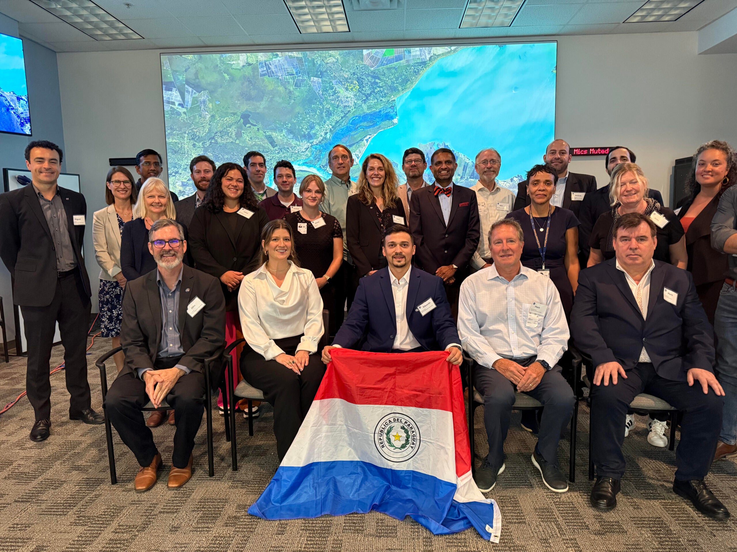 Seated with large group and Paraguayan flag (June 2025)