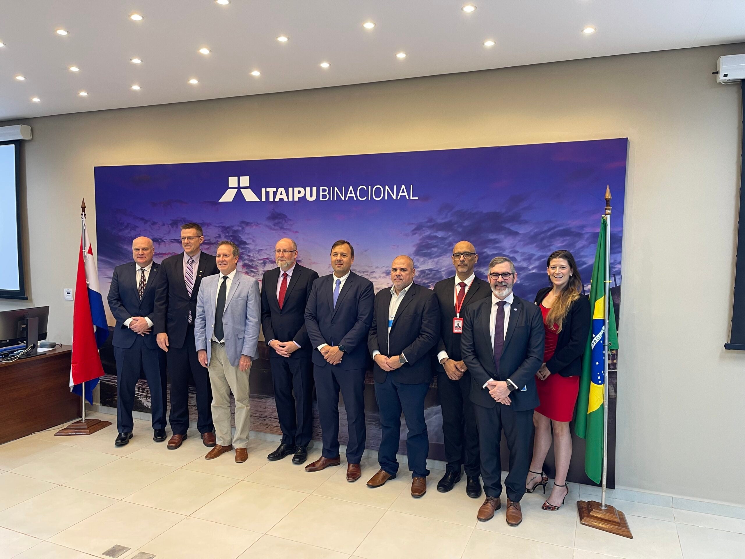 Standing with group of men  (March 2023)