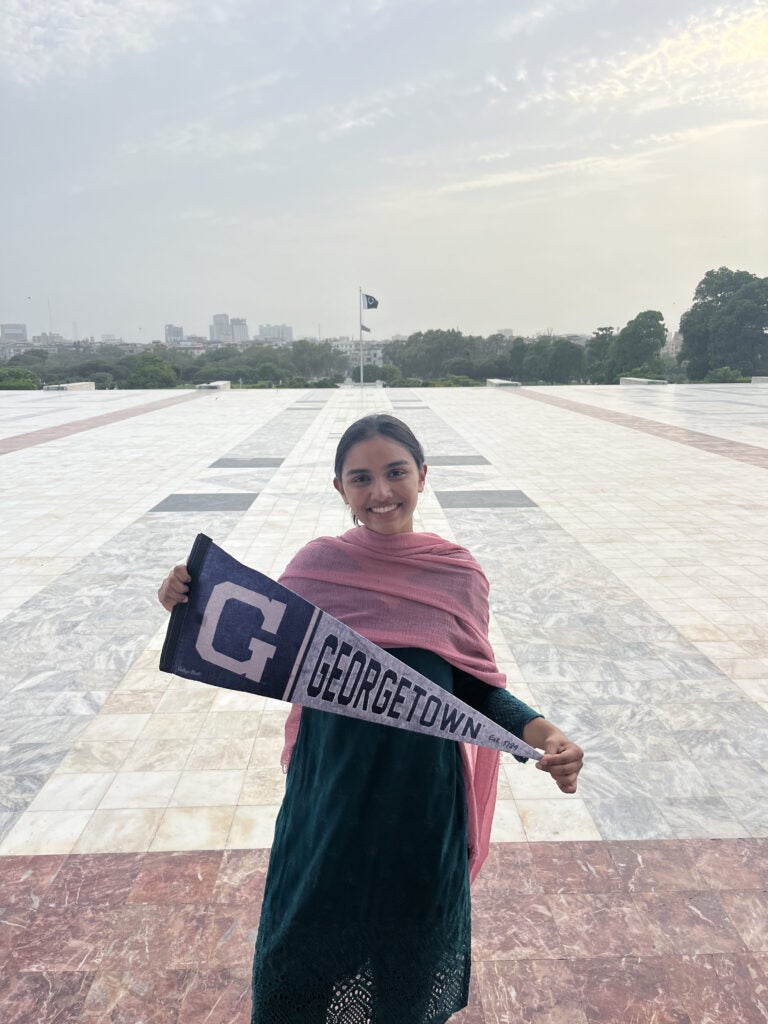 Amara holding a Georgetown banner
